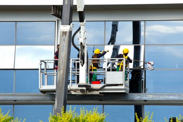 Empoli Italy - 19 May 2016: Window cleaner working on a glass facade of the building. Cleaning Maintenance of USL 11 in Dei Cappuccini street in Empoli.